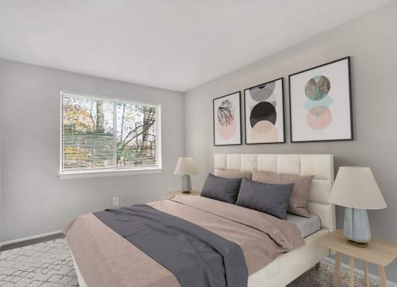 A bedroom with a large bed and three framed pictures on the wall.