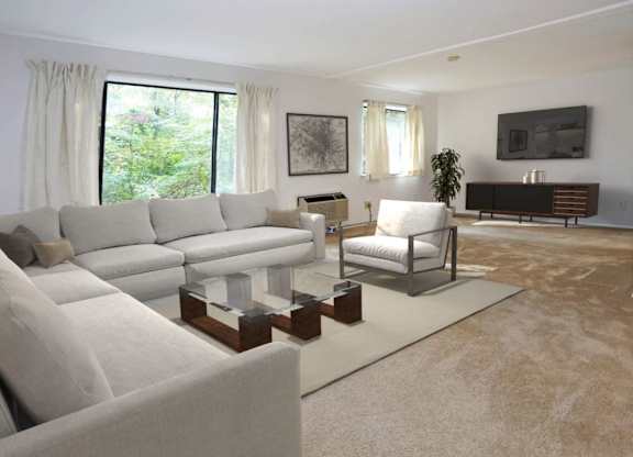 A living room with a grey sofa and a white chair.