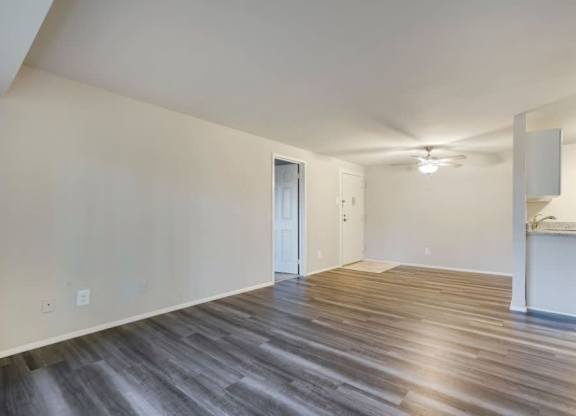 A room with wooden flooring and a white cabinet.