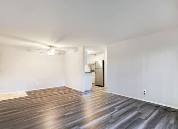 A room with wooden flooring and a ceiling fan.