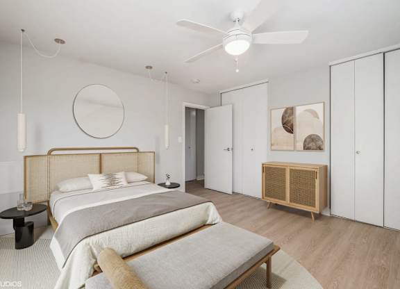 A bedroom with a large bed and a wooden headboard.