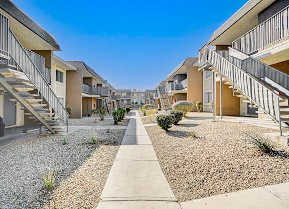 A row of houses with gravel in front of them.