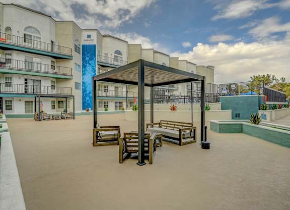 A patio area with a table and chairs under a canopy.
