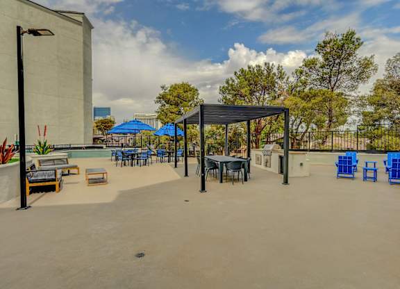 A patio area with blue chairs and tables.