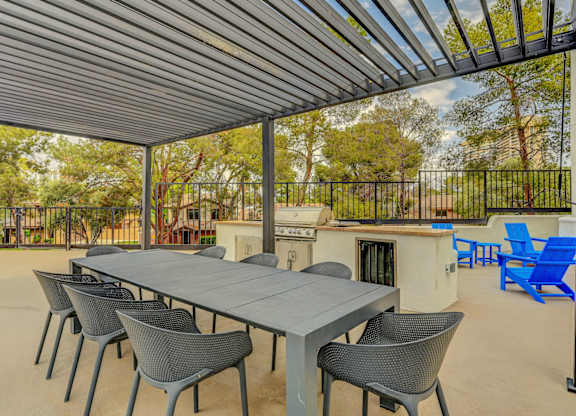 A patio with a table and chairs under a roof.