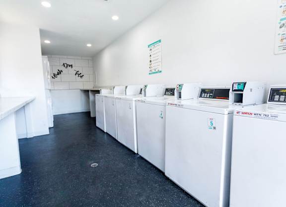 A laundromat with rows of washers and dryers.