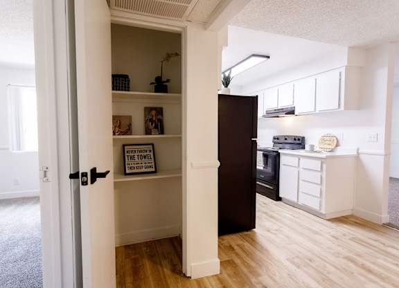A kitchen with a towel hanging on the oven.