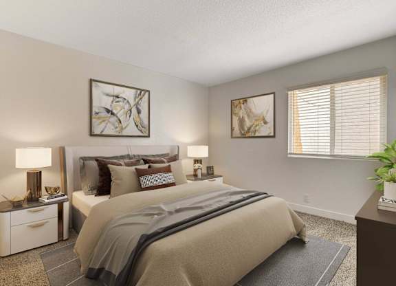 A bedroom with a large bed and two lamps on either side of it.