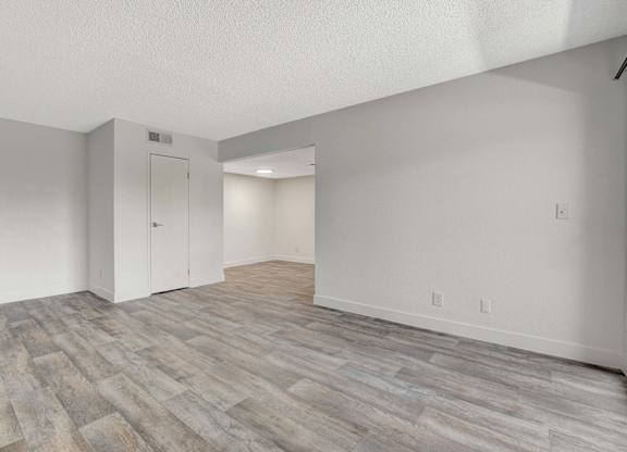 A room with a wooden floor and white walls.
