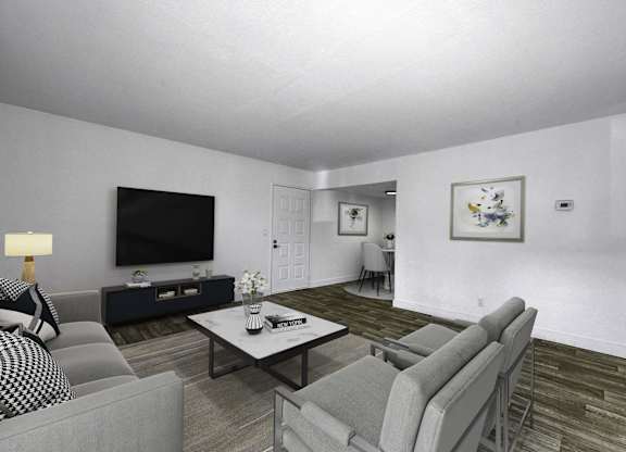 A living room with a grey couch, a black and white sofa, a coffee table, and a television.