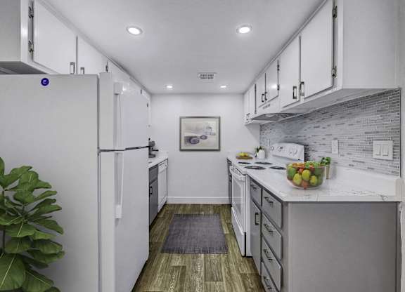 A modern kitchen with white cabinets and a wooden floor.