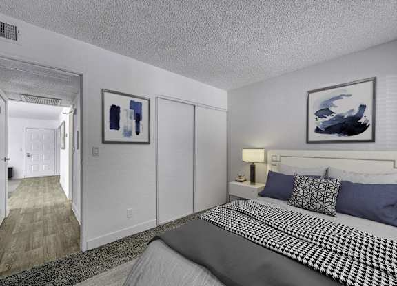 A bedroom with a large bed and two framed pictures on the wall.