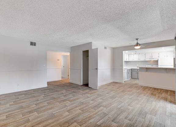 A room with a wooden floor and white walls.