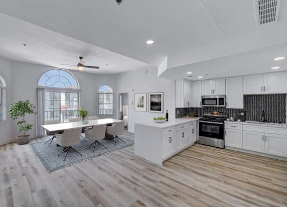 A modern kitchen with a dining table and chairs.