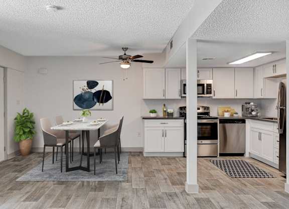 A modern kitchen with a dining table and chairs.