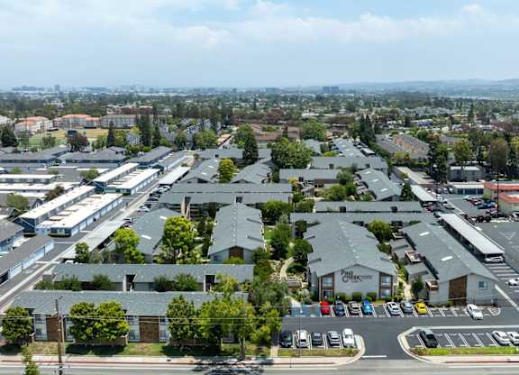 A parking lot with cars and a building with a sign that says
