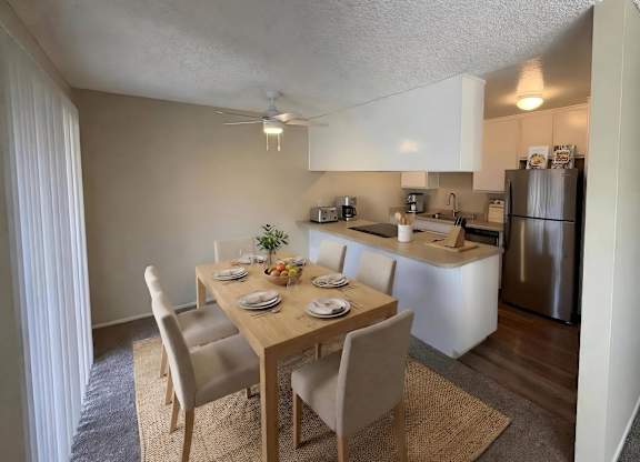 A kitchen with a dining table set for four.