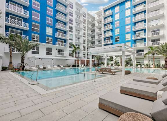 Heated zero-edge saltwater pool with sundeck, cabanas, fire pits and water feature