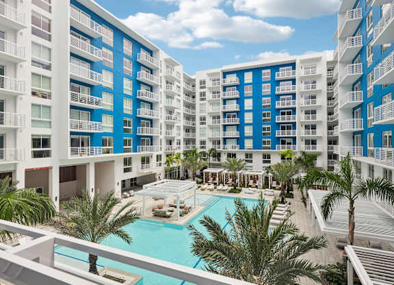 Heated zero-edge saltwater pool with sundeck, cabanas, fire pits and water feature