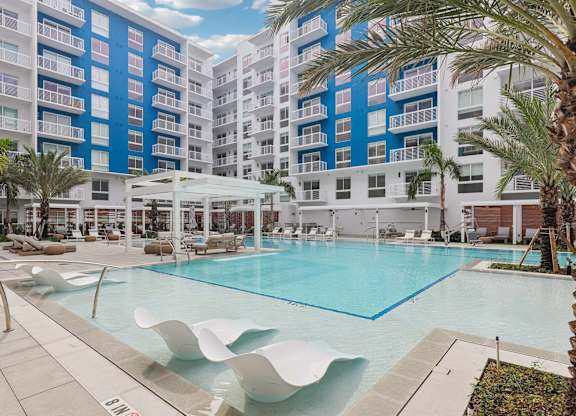 Heated zero-edge saltwater pool with sundeck, cabanas, fire pits and water feature