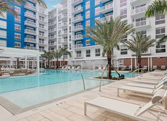 Heated zero-edge saltwater pool with sundeck, cabanas, fire pits and water feature