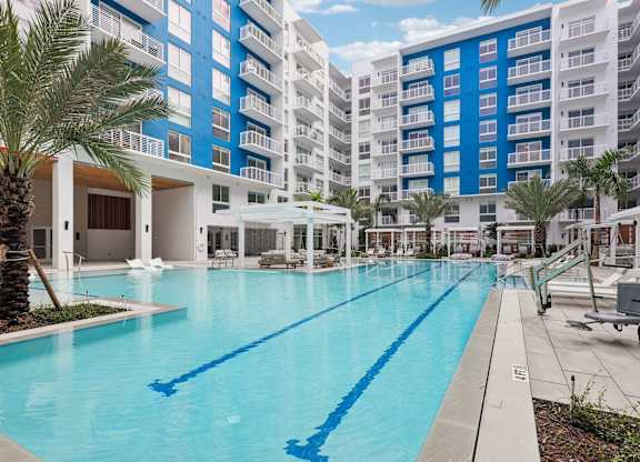 Heated zero-edge saltwater pool with sundeck and water feature