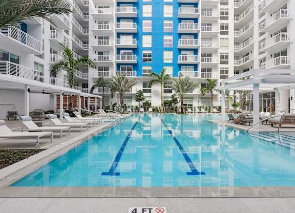 Heated zero-edge saltwater pool with sundeck and water feature