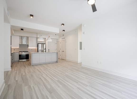 Spacious living area with hardwood-inspired flooring throughout