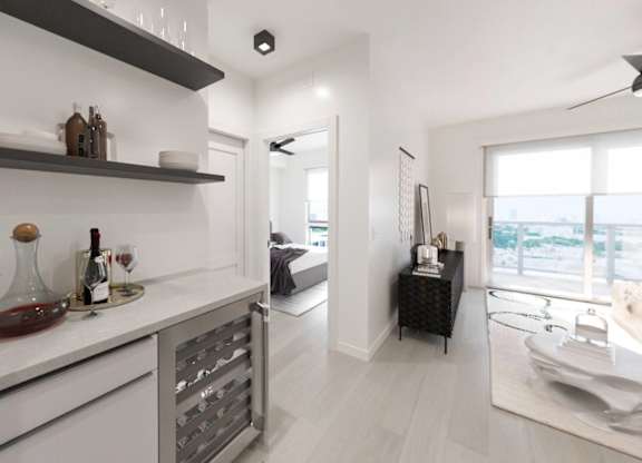 A modern kitchen with white cabinets and a marble countertop.