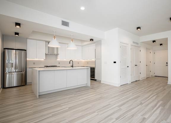 Spacious living area with hardwood-inspired flooring throughout