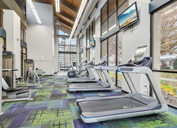A gym with treadmills and exercise equipment.