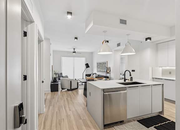 Fully-equipped kitchens with hardwood-inspired flooring throughout