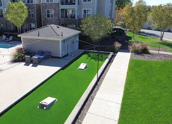 Outdoor entertainment area with cornhole