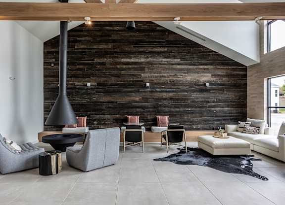 Lounge seating area and fireplace in multi-story clubhouse