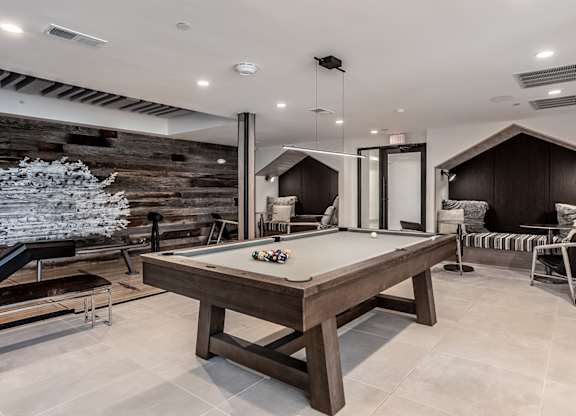 Indoor gaming lounge with billiards, foosball table, shuffleboard and mini bowling lane