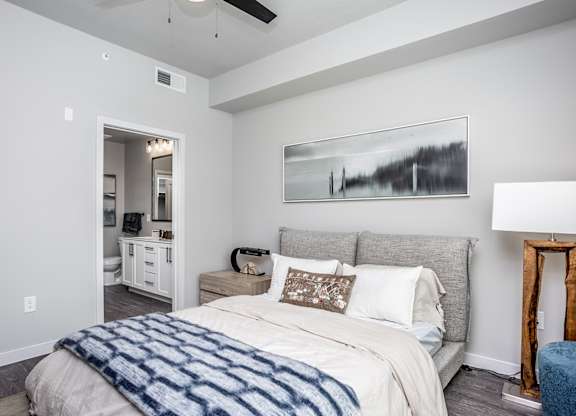 9-foot ceilings and hardwood-inspired flooring in bedroom of model