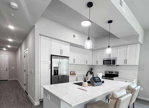 Fully-equipped kitchens with quartz countertops, stainless steel appliances, and matte black fixtures and hardware