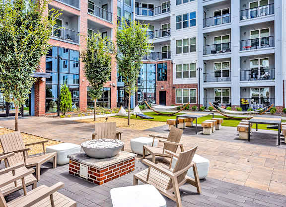 Outdoor entertaining space with fire pit, hammocks and cornhole