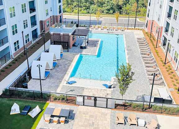 Outdoor entertaining areas with saltwater pool, cornhole, gas grills and firepit