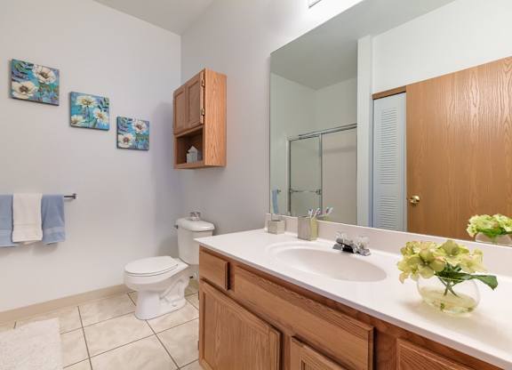 Bathrooms with tiled floors and walk-in showers