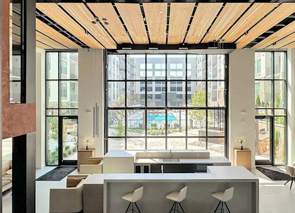 Impressive multi-story clubhouse with glass garage-style doors that open to outside