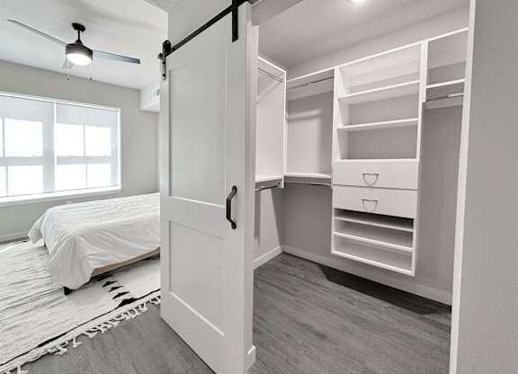 California-style walk-in closet and bedroom in model