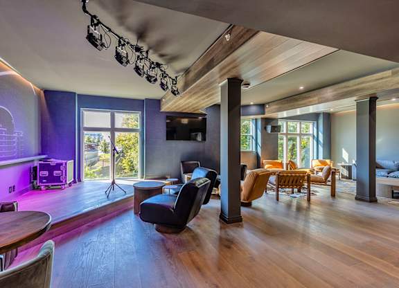 Host events in our private whiskey lounge available to rent, featuring a TV and built-in stage