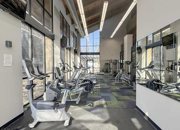A gym with treadmills and elliptical machines.