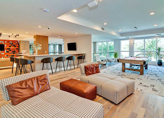 Clubhouse lounge with shuffleboard, pool table and bar area