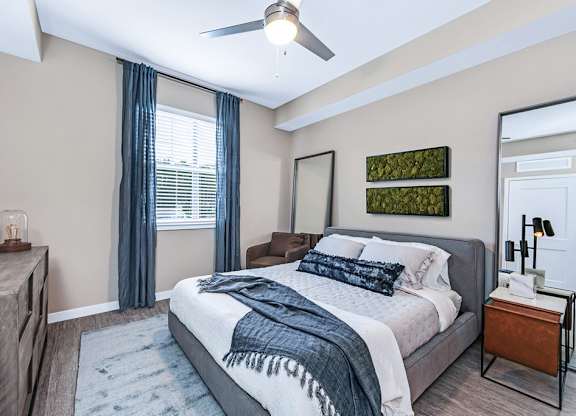 Bedrooms with hardwood-inspired flooring and ceiling fan