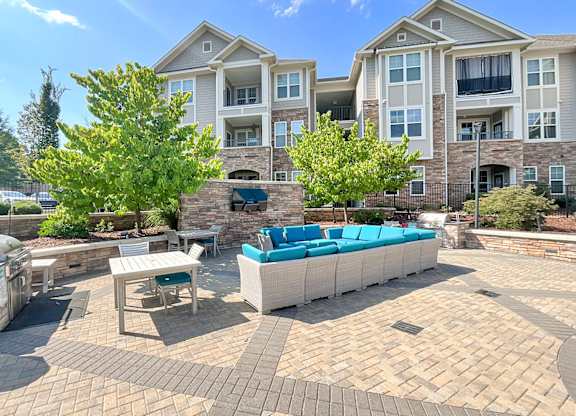 Outdoor living space for entertaining with gas grills, fire pit, entertainment lounge and game area