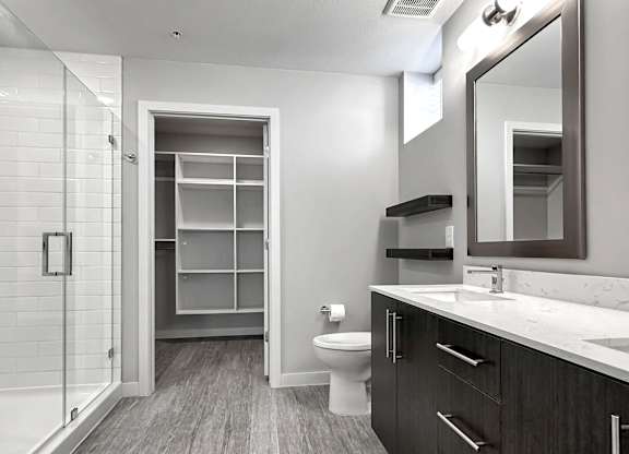 Frameless walk-in showers and large closets with custom shelving