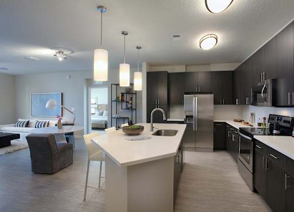 Large kitchens with stainless steel appliances and tile backsplash