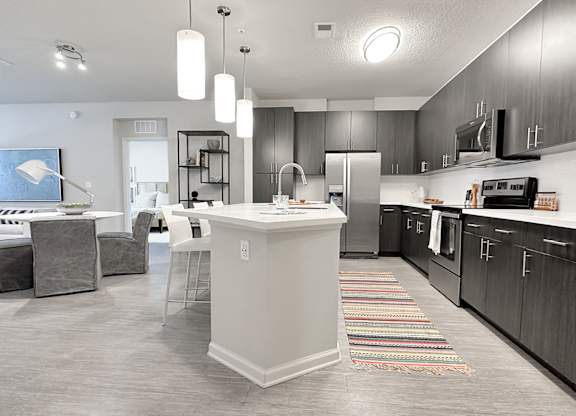 Open concept floor plans with fireplaces and large islands with bar seating